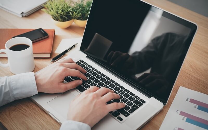 Laptop desk portraying work from home and touchless transition