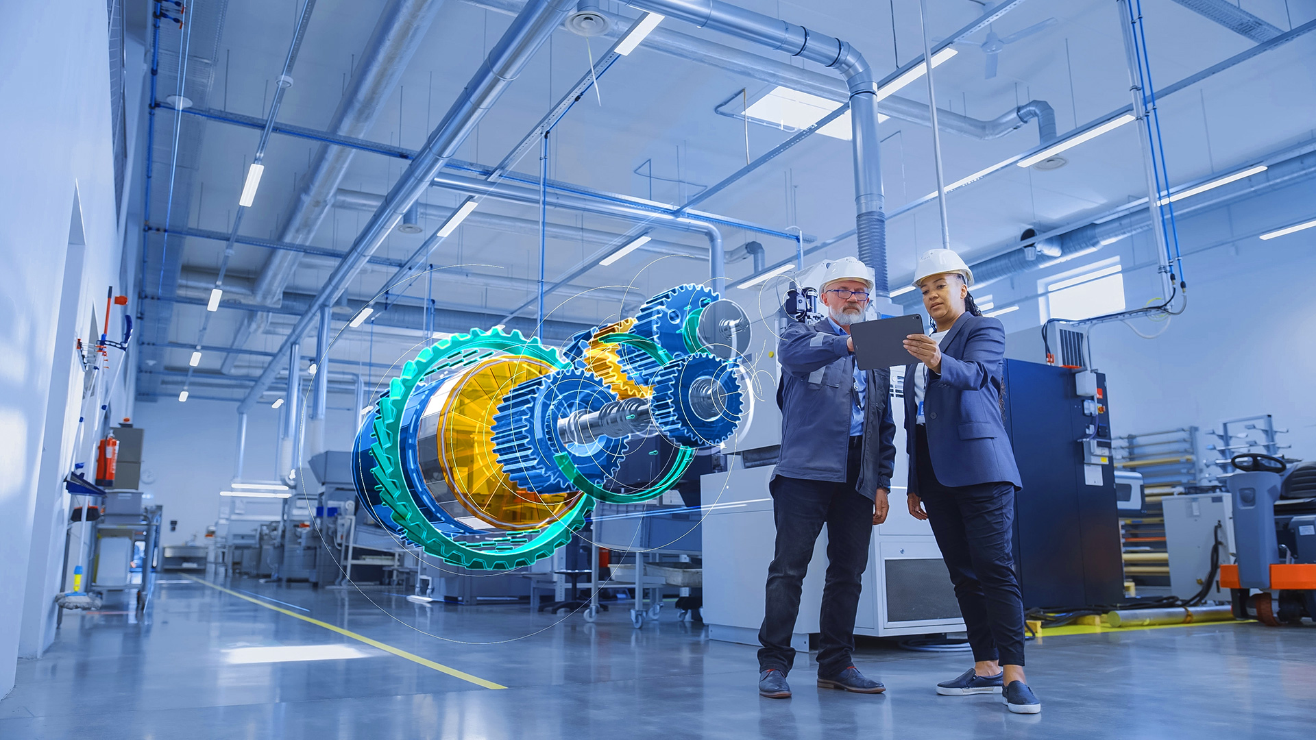 Two professionals stand before a large machine, symbolizing advancements in material discovery through AI.