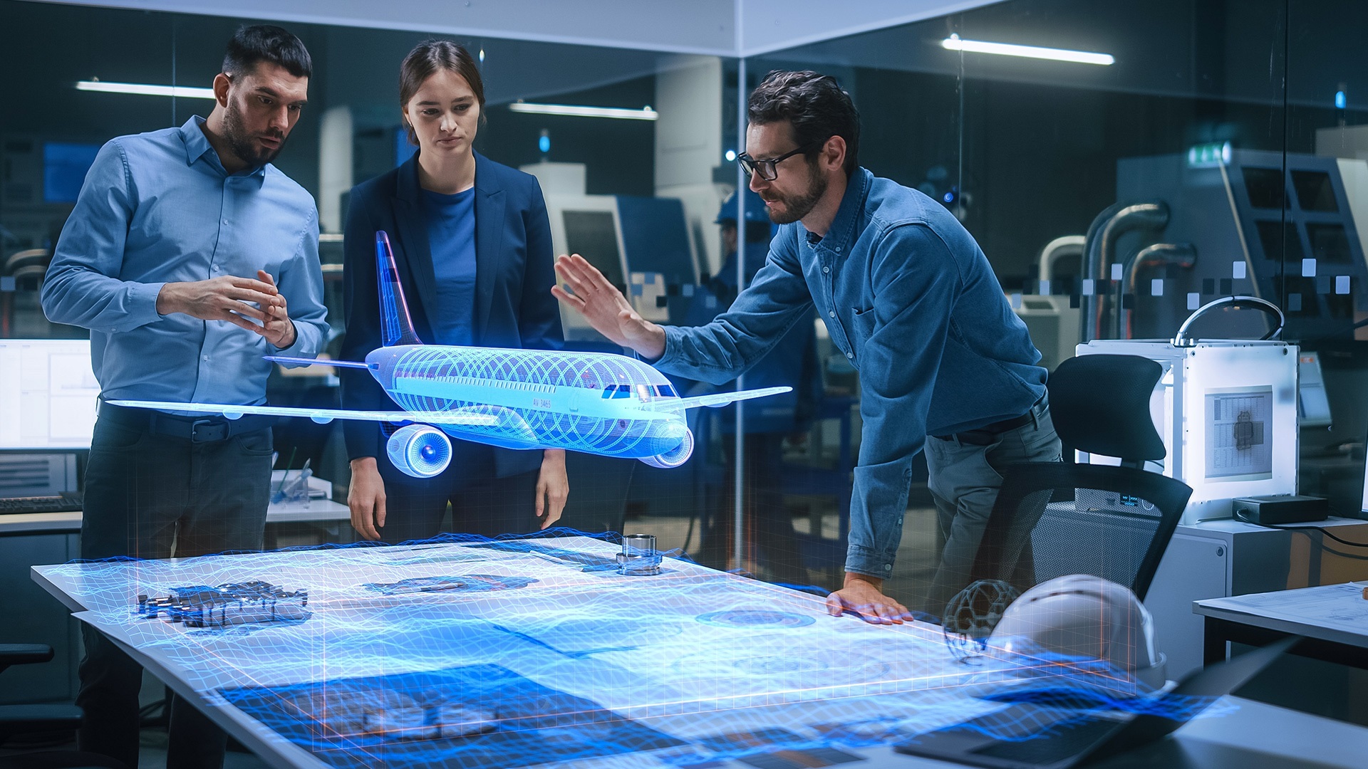 Three people examining a detailed airplane model, discussing design efficiency
