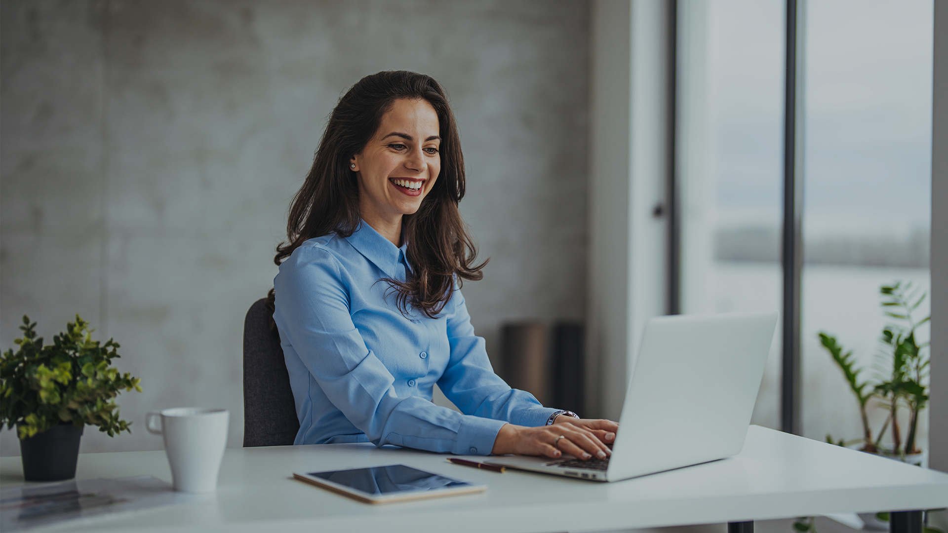 Image of a workplaces services professional working on her laptop