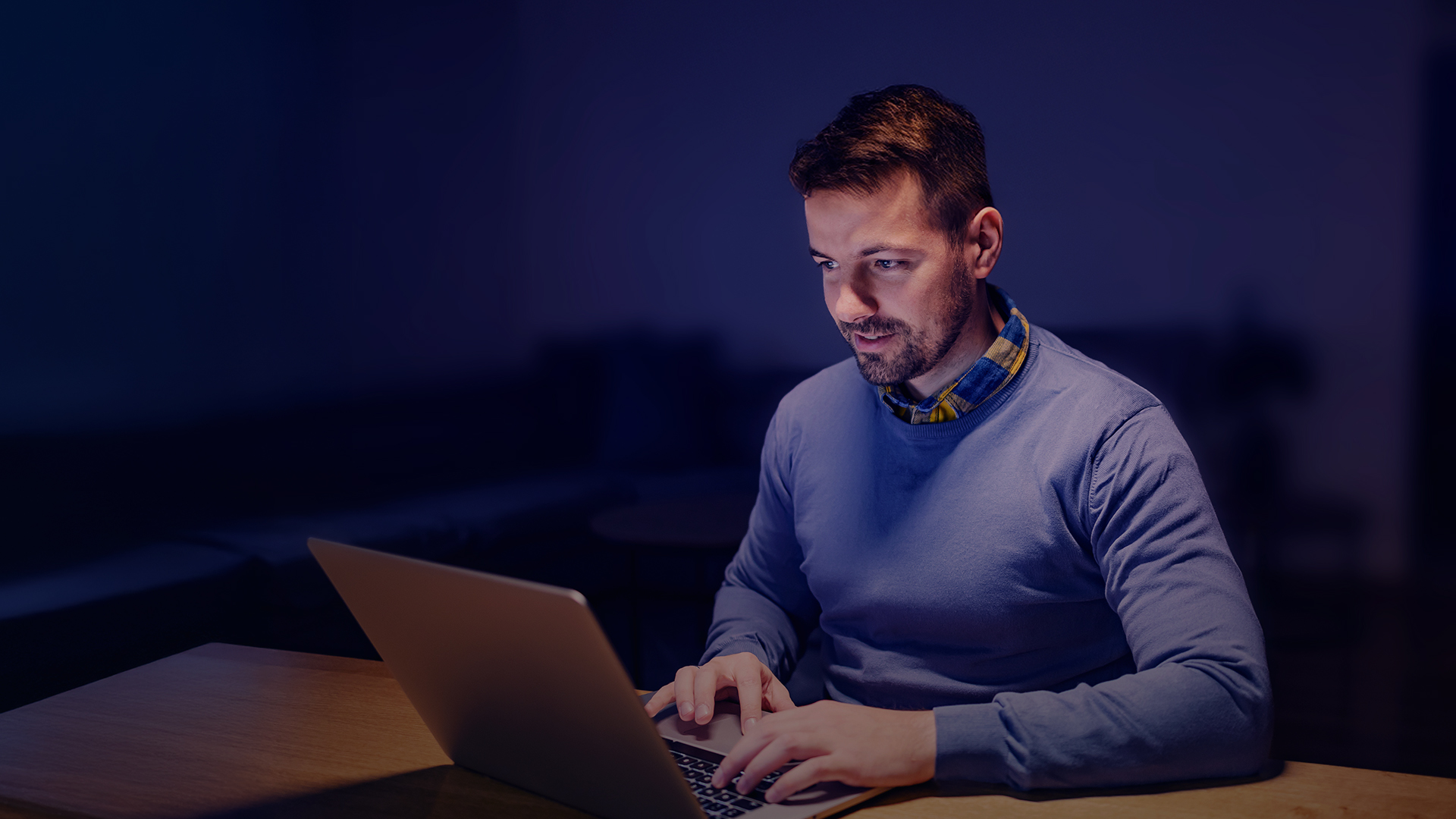 A data engineer checking new updates on his laptop from the AI-powered cheque fraud detection solution