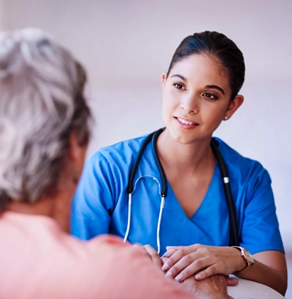 Healthcare professional consulting with an older patient during a one-on-one appointment.