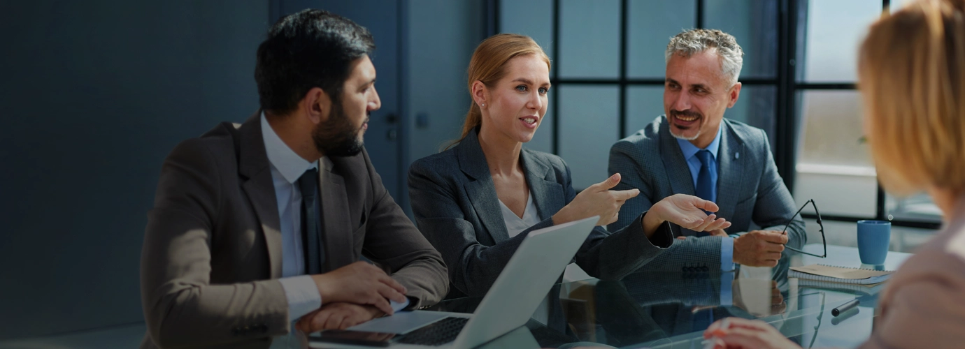 Confident business professional using a tablet outside a modern office building, symbolizing AI-powered ERP transformation with Hexaware's Amaze for ERP platform.