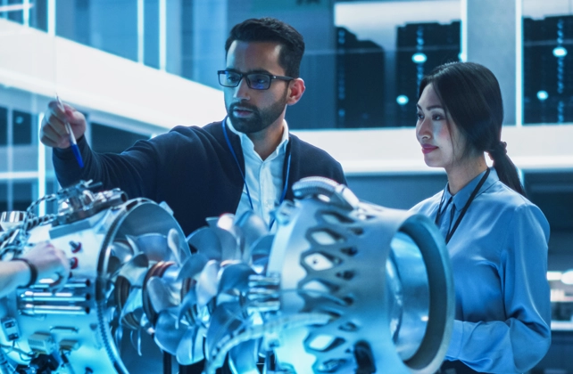 Man looking at two computer monitors while working.